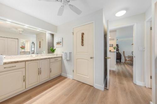 a white bathroom with a sink and a mirror at Eldorado H107 · EL H107 Updated Kaanapali Condo w Beach Cabana G in Kahana