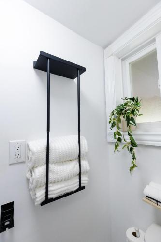 a black towel rack in a bathroom with towels at Private 2-BR Suite w Patio in Mississauga