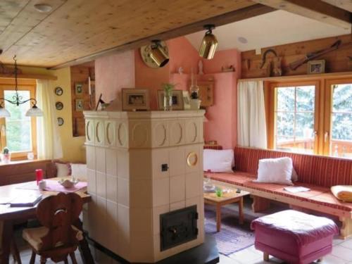 a living room with a fireplace and a table and chairs at Haus 116A in Tarasp