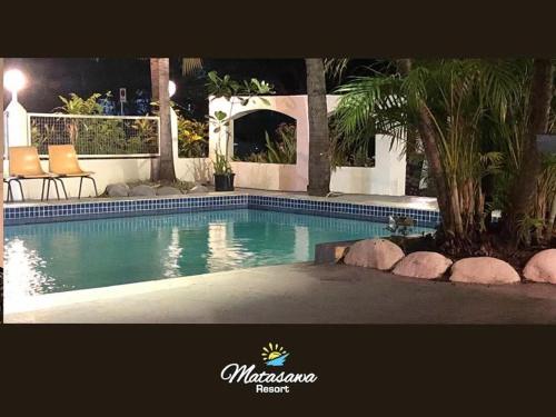 a swimming pool in front of a house at Matasawa Resort - Wailoaloa, Nadi in Nadi