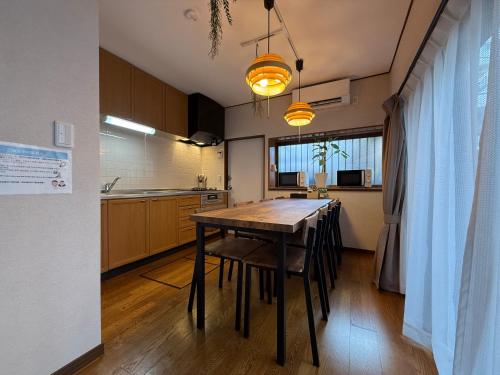 a kitchen with a table and chairs in a room at nestay villa tokyo ueno in Tokyo