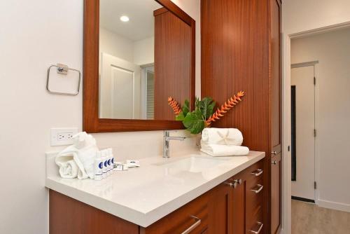 a bathroom with a sink and a mirror at Hoyochi Nikko 201 · HN 201 Relaxing Getaway OceanFront 2BD wPool in Kahana
