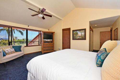a bedroom with a white bed and a ceiling fan at Kaanapali Royal D302 · KRL D302 Updated Kaanapali 2BD on Golf Co in Lahaina