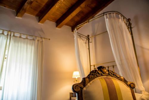 a bedroom with a canopy bed and a window at Hotel Boutique Posada Dos Orillas in Trujillo