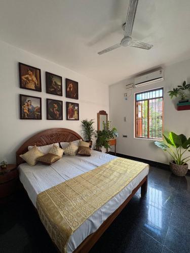 a bedroom with a large bed in a room at Yaazhi Boutique Homestay in Pondicherry