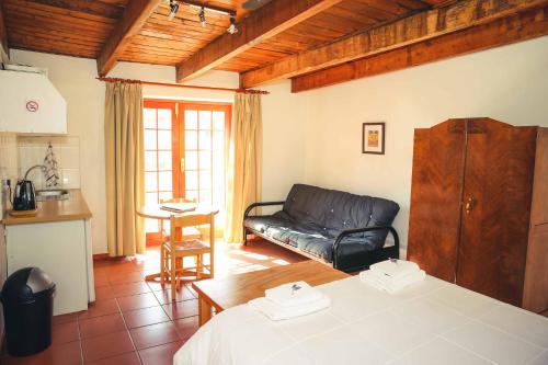a living room with a couch and a table at Wilgewandel Holiday Farm & Day Restaurant in Oudtshoorn