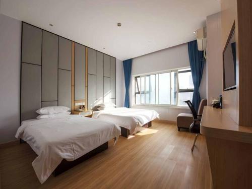 Voodi või voodid majutusasutuse Hanting Hotel Shanghai Railway Station North Square toas