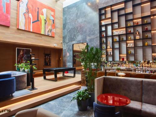 a lobby of a hotel with a bar at Pullman Lima Miraflores in Lima