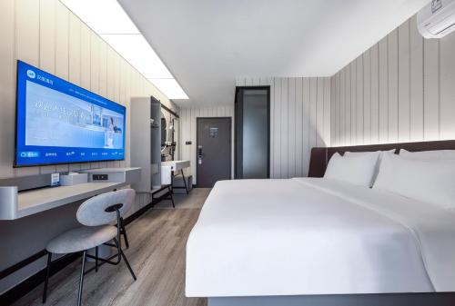 Ένα ή περισσότερα κρεβάτια σε δωμάτιο στο Hanting Hotel Shanghai Taopu New Village Subway Station