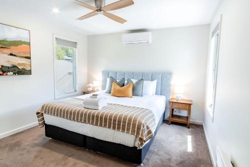 a bedroom with a bed and a ceiling fan at Amber Mist Villa - Two in Bright