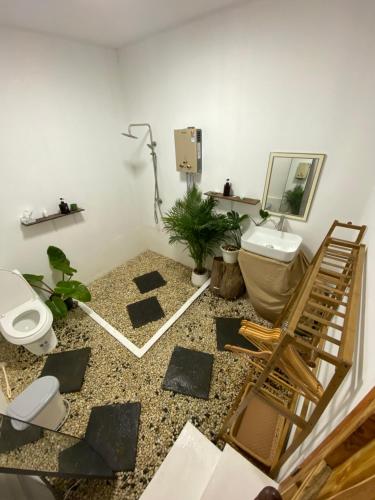 a bathroom with a toilet and a sink at อะบู้ศรีโฮมสเตย์ in Ban Huai Khai