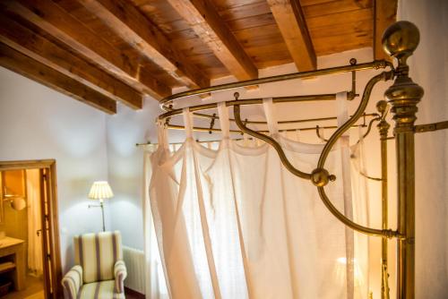 a bedroom with a bed with a white curtain at Hotel Boutique Posada Dos Orillas in Trujillo