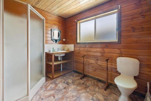 a bathroom with a toilet and a sink at Neptune's Nook in Cape Paterson