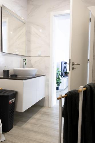 a bathroom with a sink and a mirror at Casa Pedra de Sal in Ribeira Grande