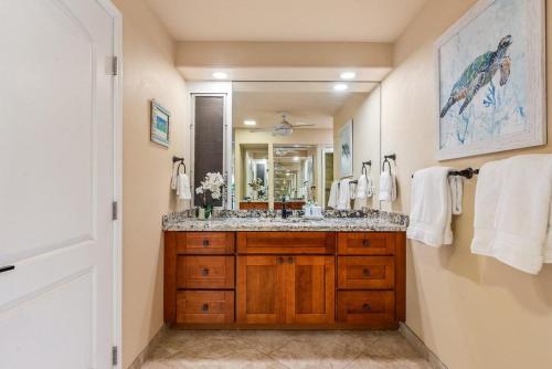 a bathroom with a sink and a large mirror at Eldorado E102 · EL E102 Quiet Condo w Lanai AC Beach Cabana Gym in Kaanapali