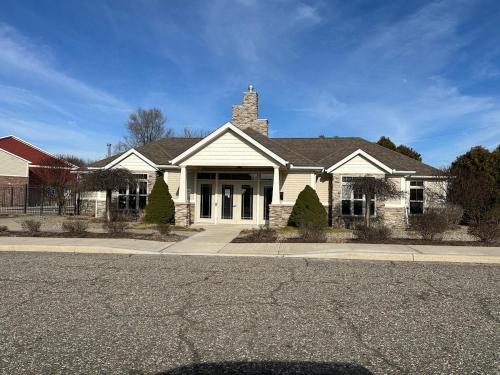 a white house on the side of a street at Game Day Getaway 5 Min from Notre Dame in Mishawaka