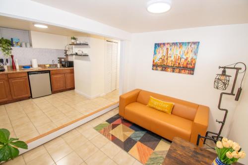 a living room with a couch and a kitchen at Cozy 1 Bedroom Apt - Minutes to NYC - Great for Remote Work in North Bergen
