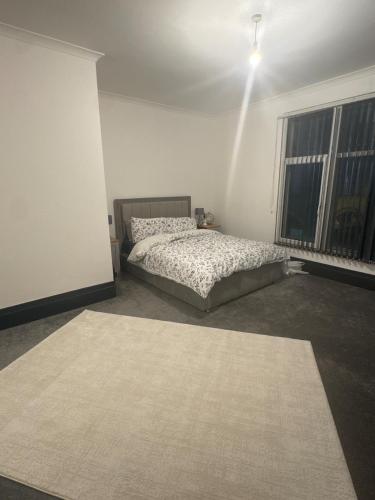 a bedroom with a bed and a rug at Huddersfield City Center Retreat - New Images coming soon in Huddersfield