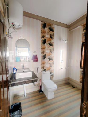 a bathroom with a sink and a toilet at Whispering Meadows in Shimla