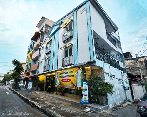 a blue and white building on the side of a street at Thepmongkol House in Bangkok