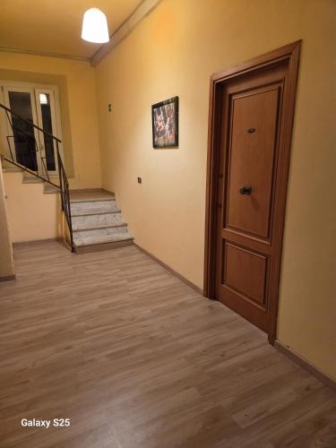 an empty hallway with a door and stairs at Giappone Inn Flat in Livorno