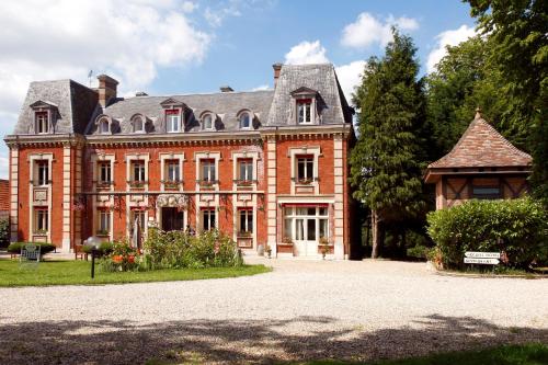 a large red brick building with a roof at Château Corneille in Vieux-Villez