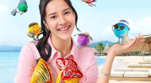 a woman holding two birds on a beach at Hotel Wijaya Magelang in Magelang