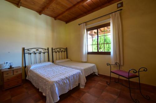 a bedroom with two beds and a window at Casas Rurales Tola in El Paso