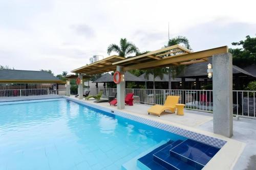 a pool at a hotel with chairs and a pavilion at Venue 88 in Dulongabong