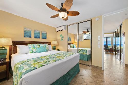 a bedroom with a large bed and a television at Papakea L101 · PK L101 Maui Ground-Floor Condo with Ocean Views in Honokowai