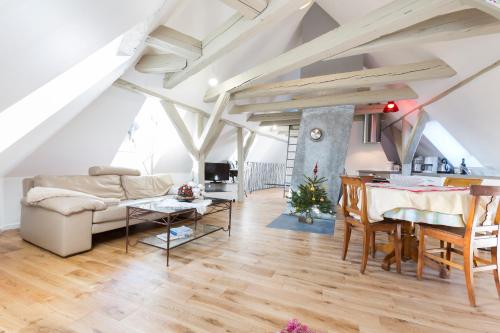 a living room with a table and a couch at Les Appartements Saint Nicolas in Colmar