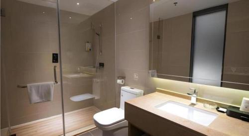 a bathroom with a toilet and a sink and a shower at City Comfort Inn Jiangmen Enping Bus Terminal in Enping