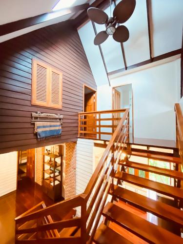 a staircase leading up to a house with a ceiling fan at Baan Zen - 6 PAX Waterfront Retreat - 200 mt from the beach in Ban Map Khangkhao