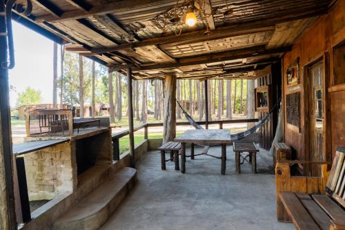 a porch of a house with a hammock at Cabañas en el Bosque a 5 minutos del mar - Estancia CH in Punta del Este