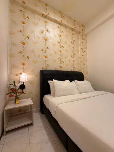 a bedroom with a bed with a flowery wall at Jade Guesthouse Jonker Street Melaka in Malacca