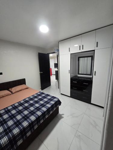 a bedroom with a bed and a flat screen tv at Raiwai homestay in Suva