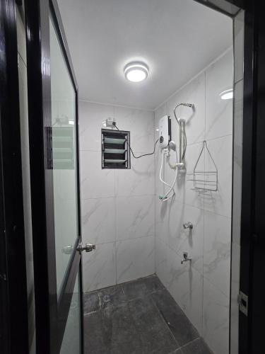a bathroom with a shower with a glass door at Raiwai homestay in Suva