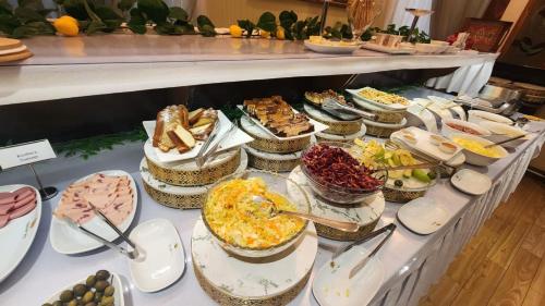 a buffet with many different types of food on a table at Baku Khatai Central Hotel in Baku