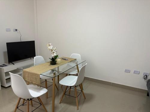 a dining room with a table and white chairs at Benjamin 194 Suites in La Rioja