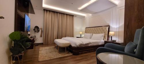 a hotel room with a bed and a couch at Goldcrest Luxury Apartments in Lahore
