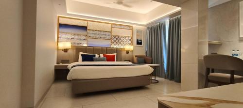 a bedroom with a bed and a desk and a chair at SILVER INN, Andheri in Mumbai