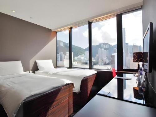 Ένα ή περισσότερα κρεβάτια σε δωμάτιο στο J Link Hotel