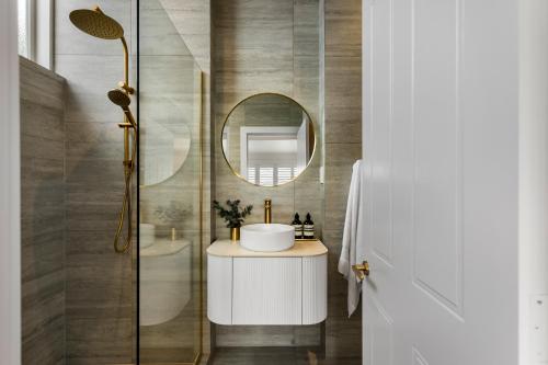 a bathroom with a sink and a mirror at Luxury Ponsonby Villa in Auckland