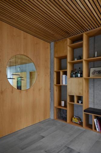 a room with a round mirror and a wooden wall at Luxury Villa With Garden Sauna, near Aarhus City in Højbjerg