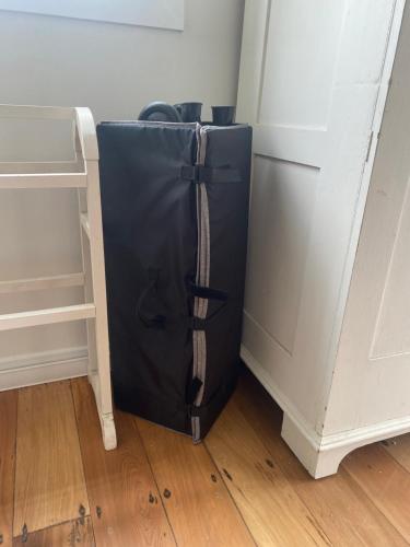 a black bag sitting on the floor next to a door at Russell Waterfront Historic Cottage in Russell