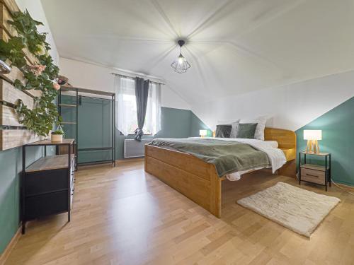 a bedroom with a bed in a room with blue walls at Grand Triplex 140m2 dans les Vosges in La Celle-sous-Gouzon