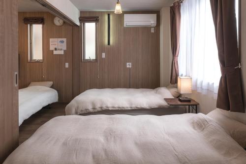 Postel nebo postele na pokoji v ubytování Lumen豊田 中長期滞在向コンドミニアム トヨタ自動車本社徒歩5分