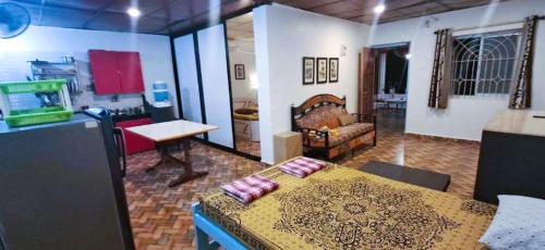 a room with a bed and a living room at Private Spacious family 1 Bhk Apartment in Arambol in Jāmb