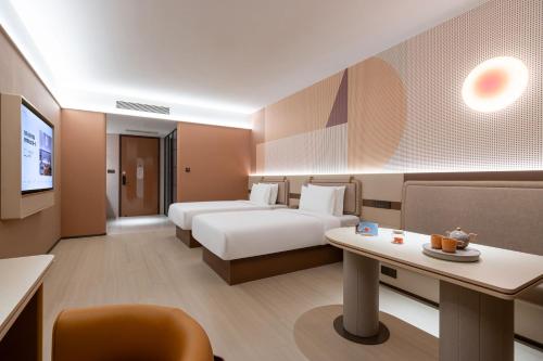 Ένα ή περισσότερα κρεβάτια σε δωμάτιο στο Orange Hotel Beijing Shiliuzhuang Subway Station