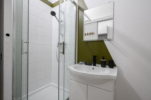 a bathroom with a sink and a shower at Aréva - Provençal - Climatisé - Parking in Ventabren